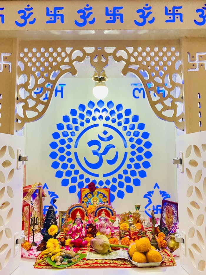 A colorful Hindu altar with religious symbols and offerings for a traditional puja ceremony.
